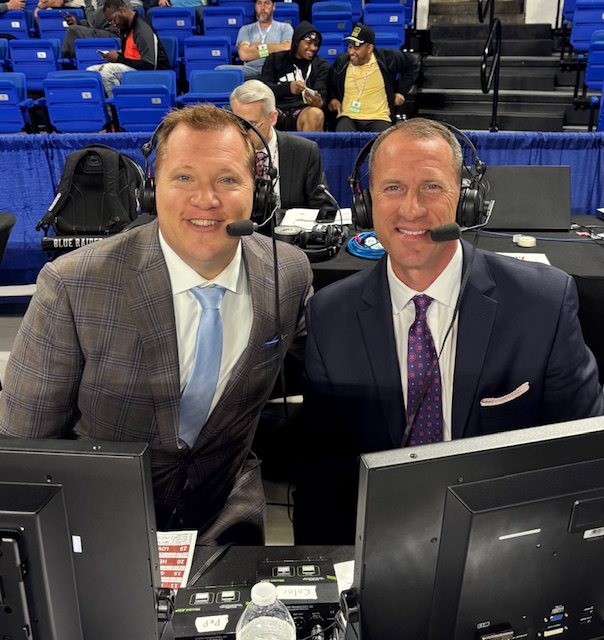 Jeff Hem on the left and Kevin Maggard on the right wearing broadcast headsets courtside